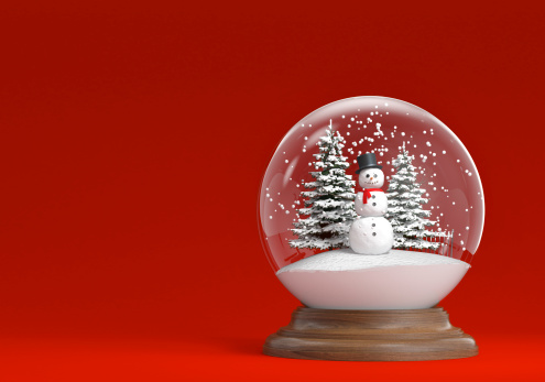 snowglobe with snowman and trees on red