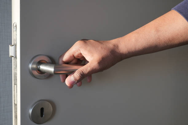 istock Man's Hand Opening door close up 1541886118