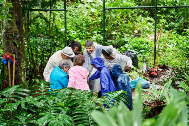 istock Diverse community cleanup volunteers standing with hands together in a huddle 1541895940