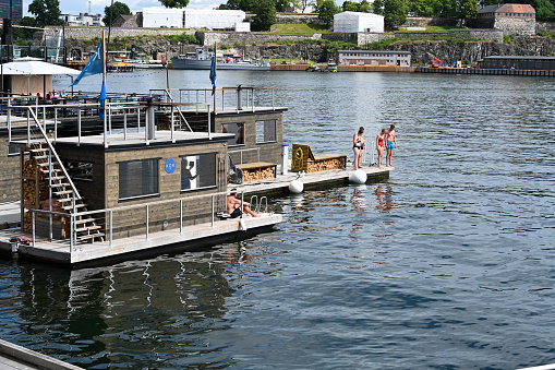 Oslo, Norway, July 7, 2023 - Oslo's floating saunas in the harbor near the Opera House.