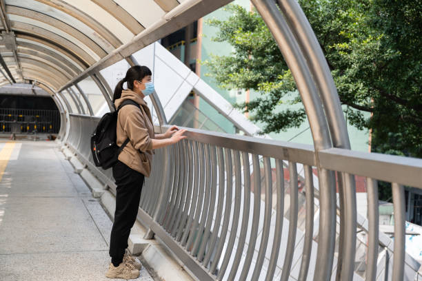 istock A female tourist stands on a pedestrian overpass 1541945114