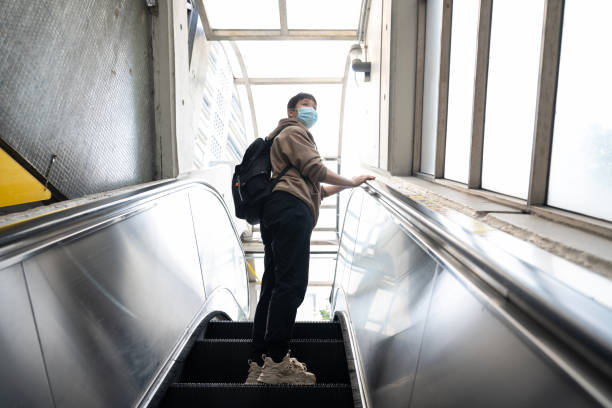 istock A female tourist is taking a public escalator 1541945116