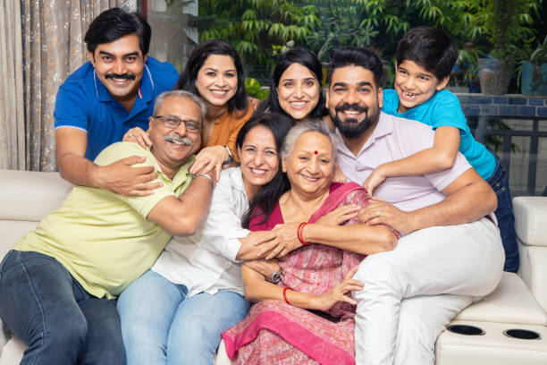 Portrait of Happy indian joint family sitting together at home. Asian senior and young couple with their kids having and laughing. Portrait of Happy indian joint family sitting together at home. Asian senior and young couple with their kids having and laughing. indian extended family stock pictures, royalty-free photos & images