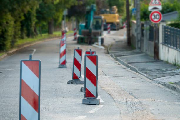 Restrictive plastic poles to control traffic on the road during repair work in a residential area of the city