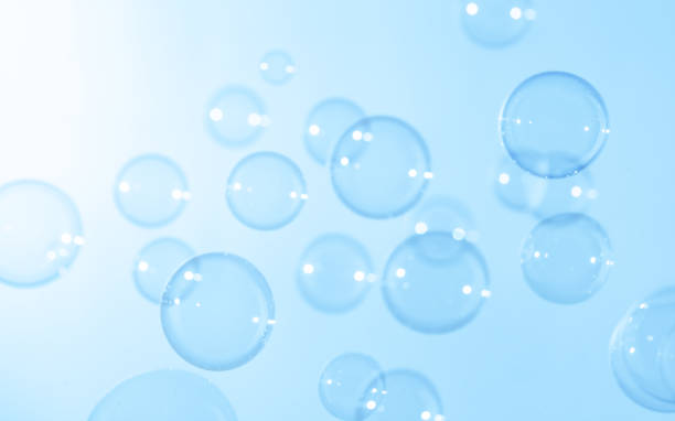 istock Beautiful Transparent Blue Soap Bubbles Floating in The Air. Abstract Blurred Background. Celebration Festive Backdrop.  Soap Suds Bubbles Water 1541957630