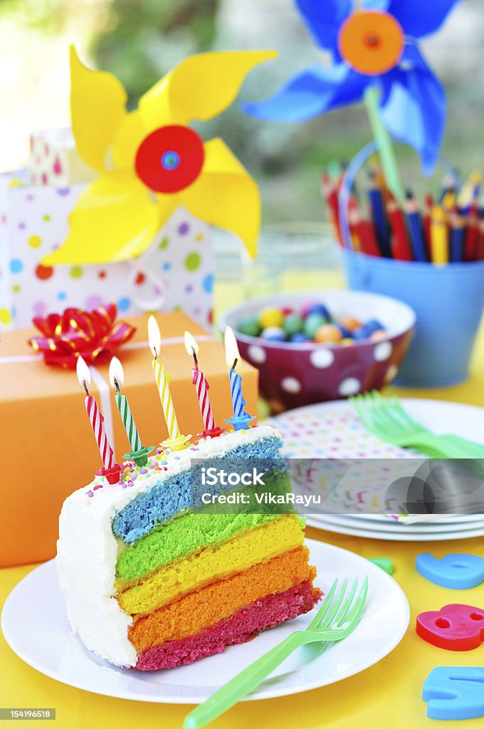 Birthday cake Slice of colorful layer cake on the birthday table Alphabet Stock Photo