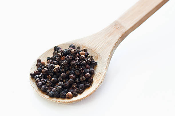 istock Black peppercorns in wooden spoon 154197241