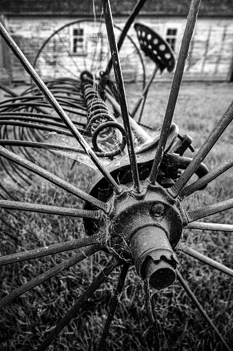 Antique Harrow in front of an old barn