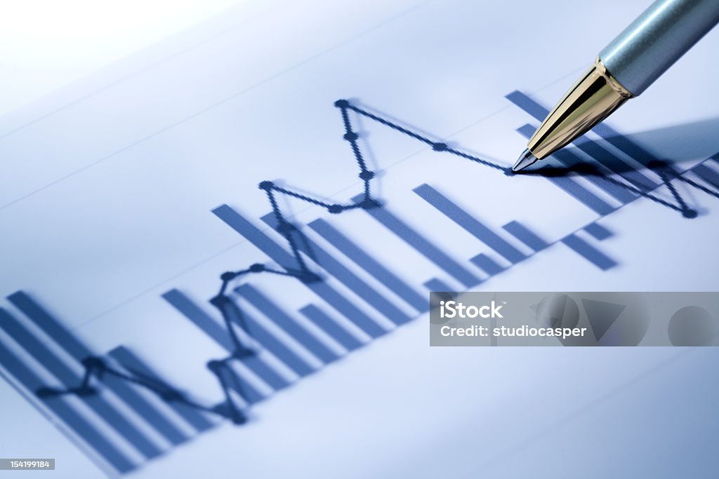 Business data Closeup of a Business Graph with pen Analyzing Stock Photo