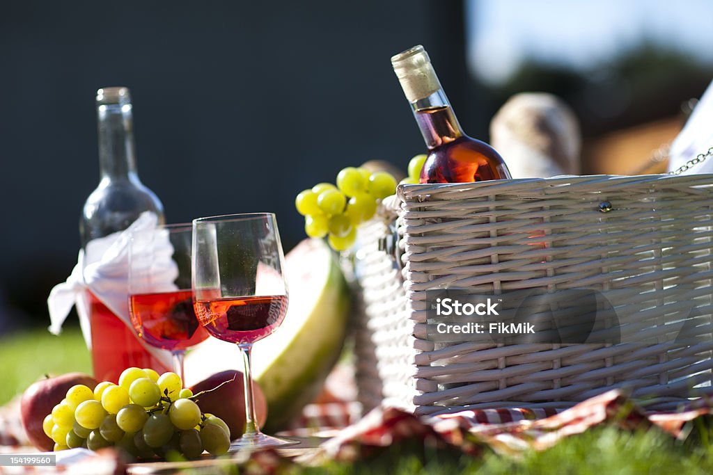 Picnic Time! Fresh food from picninc basket on grass in the garden Basket Stock Photo