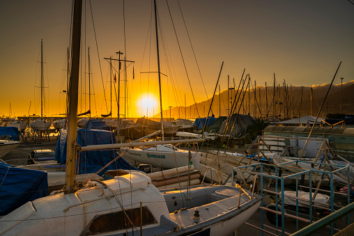 Salerno, Italy - 25th Dec 2022: Boats docking at the Port of Salerno at sunset