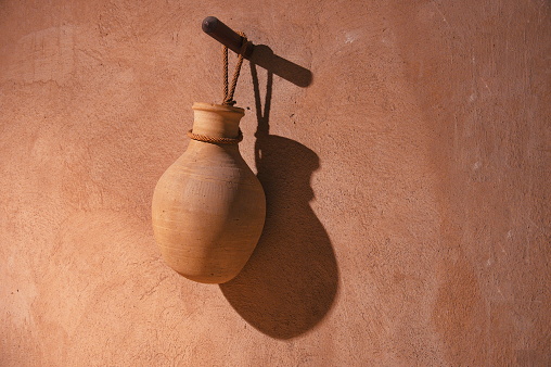Handmade clay water jar hanging in traditional village house