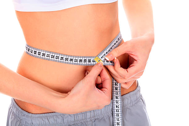 istock woman measuring her waistline 154205939