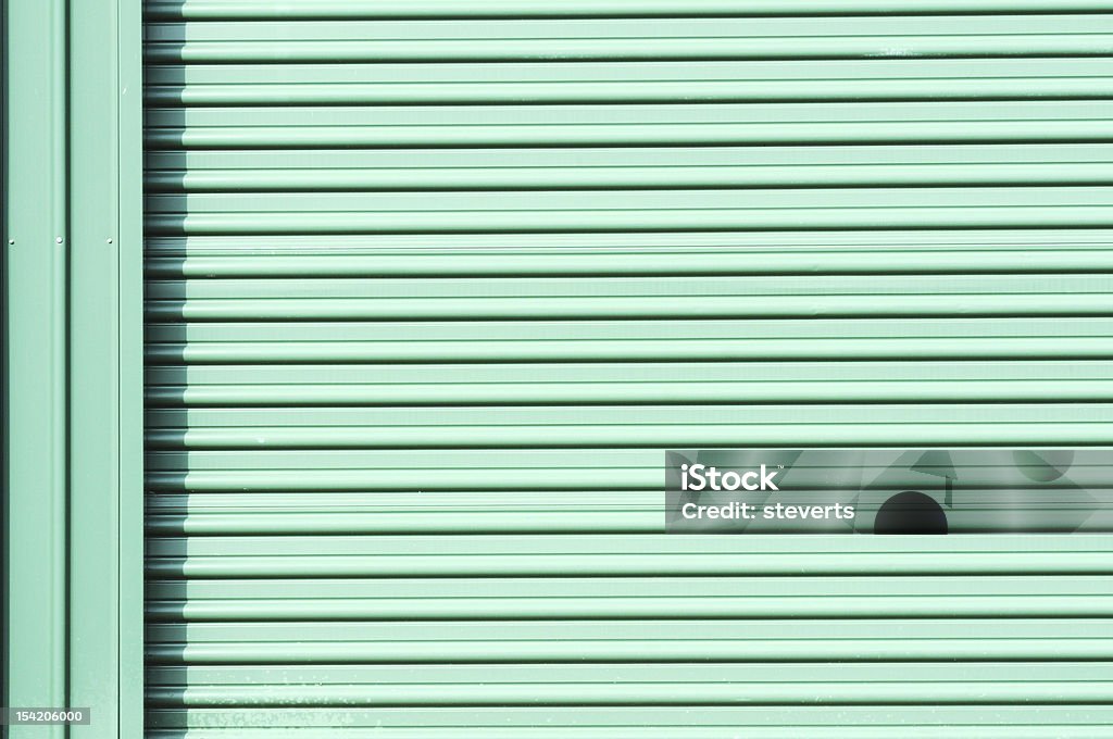 Garage Door Green garage door on self-storage shed. Backgrounds Stock Photo