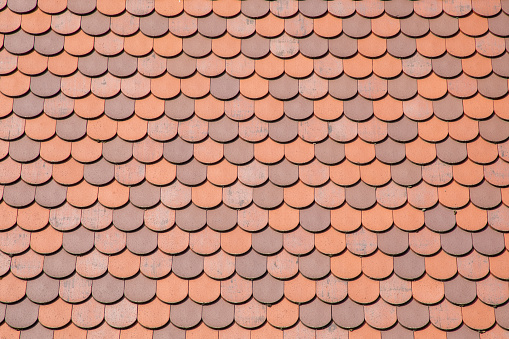 Red tile roof clay tiles roof of a private house made of shingles