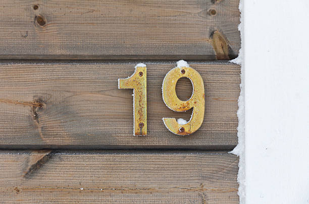 istock Number 19 on a snowy wooden wall. 154210231