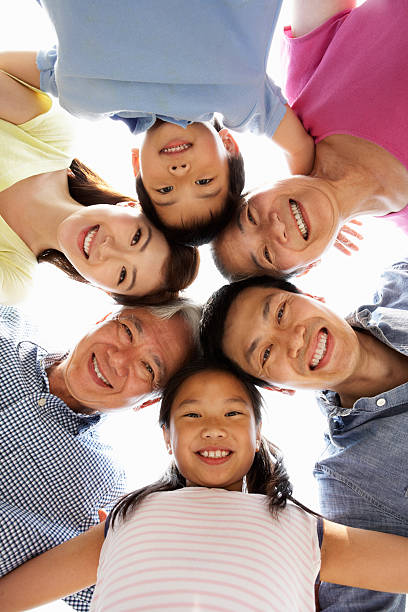 Portrait Of Multi-Generation Chinese Family Looking Down Portrait Of Multi-Generation Chinese Family Looking Down Into Camera Smiling china chinese ethnicity smiling grandparent stock pictures, royalty-free photos & images