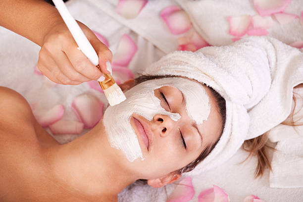 Young women getting facial mask