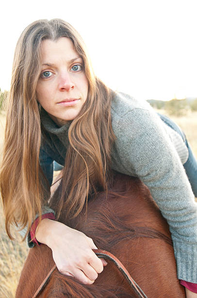 Kobieta leżący na brązowy Koń – zdjęcie