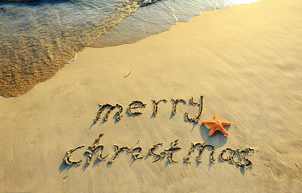 istock Merry Christmas handwritten in sand on a beautiful beach 154214571