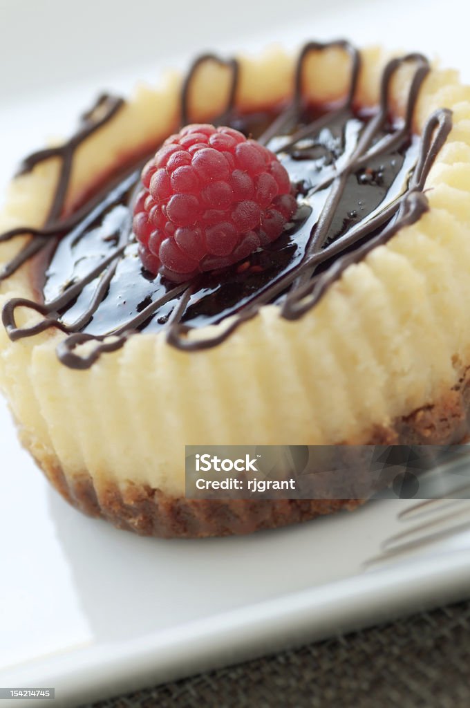 Raspberry Cheesecake Individual baked cheesecake with fresh fruit and chocolate Baked Stock Photo