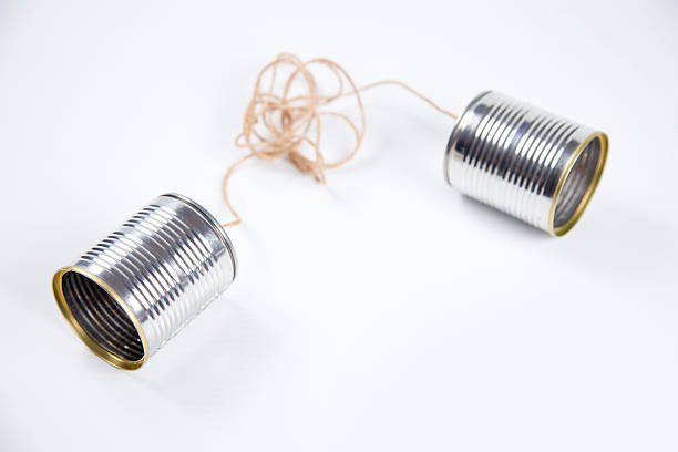 Miscommunication Old fashioned phone cans with tangled lines. communication problems stock pictures, royalty-free photos & images