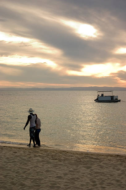 istock Young Couple Walking on Beach at Sunset 154215873