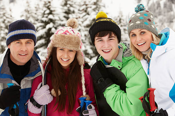 Family On Ski Holiday In Mountains Family On Ski Holiday In Mountains Smiling To camera snowboarding snowboard women snow stock pictures, royalty-free photos & images