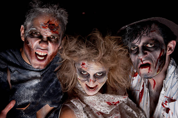 zombie zombie monsters on the prowl, outdoor shoot against a pitch black sky. halloween face paint stock pictures, royalty-free photos & images