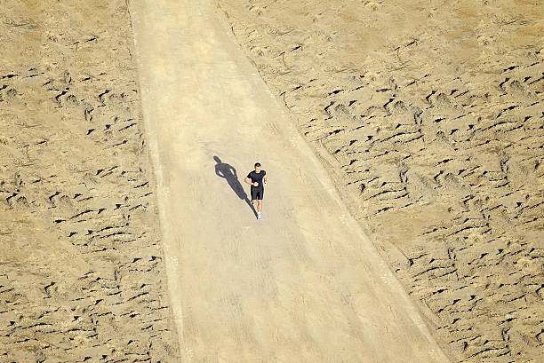 istock Man is running in desert on a sunny day 154216572