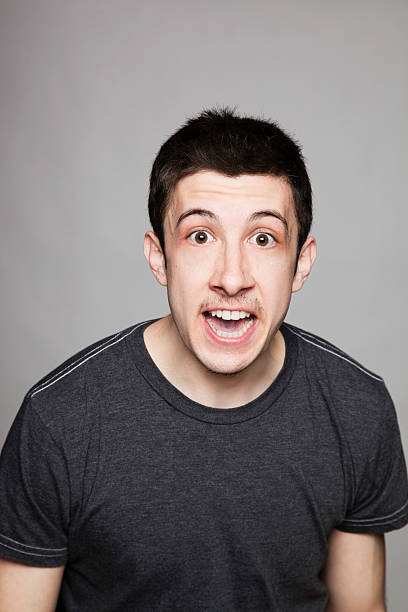 istock Young man in t-shirt looking surprised and excited 154216717