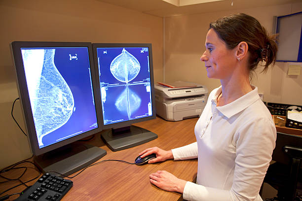 Radiology technician reviewing mammography results Radiology technician examens mammography test on location x ray image medical occupation technician nurse stock pictures, royalty-free photos & images