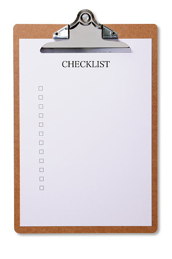 Overhead shot of wooden clipboard with checklist, isolated on white with clipping path.