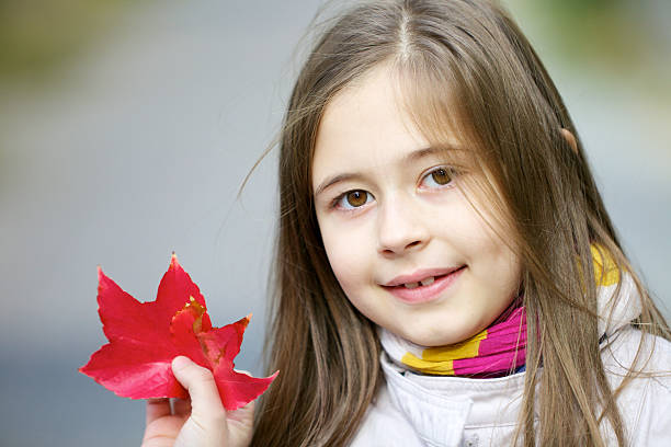 istock Girl holding read autumn leaf 154218310