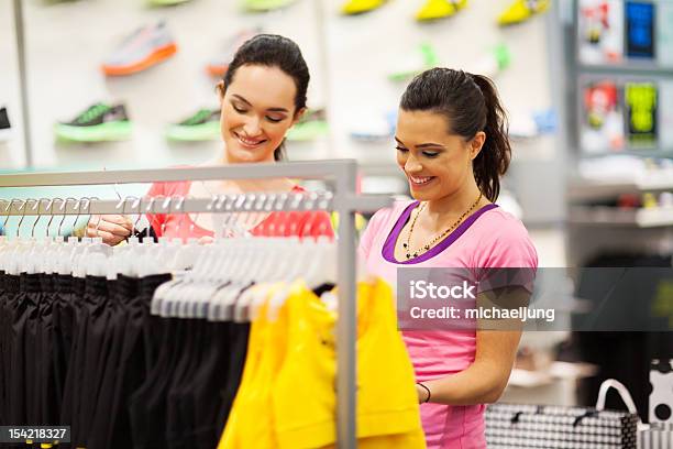 Young Women Shopping For Clothes In Sports Shop Stock Photo - Download Image Now - Sports Clothing, Sports Shop, Shopping