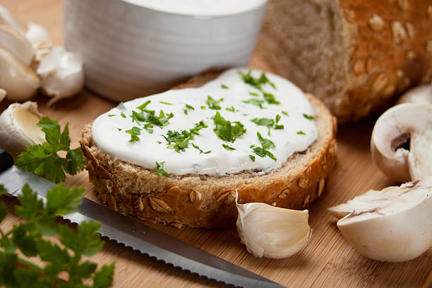 Cream cheese on a piece of bread stock photo