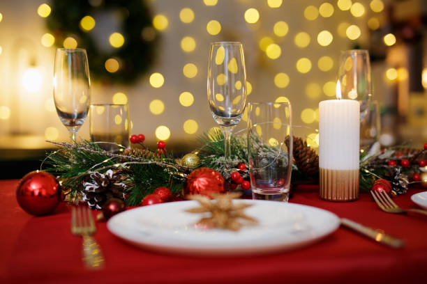 istock Table served for festive dinner. Living room decorated with lights 1542215108