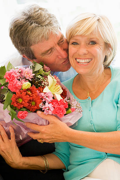 istock Husband giving wife flowers 154221942