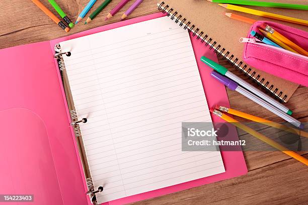 Students Desk With Notebook Binder And Writing Utensils Stock Photo - Download Image Now