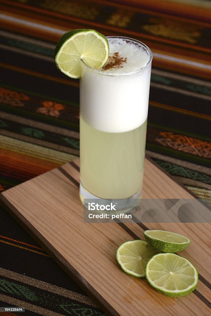 Pisco Sour on a Peruvian table Pisco Sour coktail standing on a Peruvian table with handmade tablecloth Pisco Sour Stock Photo