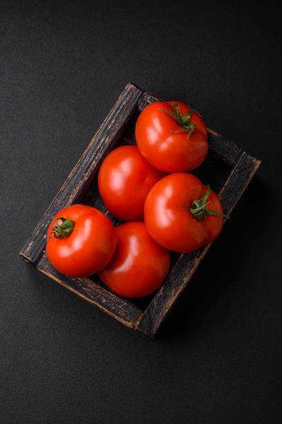 istock Delicious fresh juicy tomatoes on a dark concrete background 1542262119