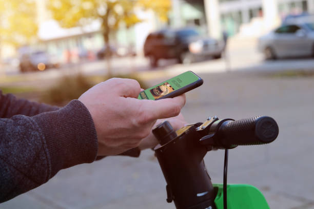 istock Man  on an electric scooter is ordering  food on  the internet using an app outside 1542273203