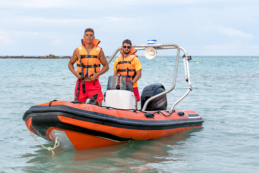 Portrait of two Lifeguards on a boat in the sea
