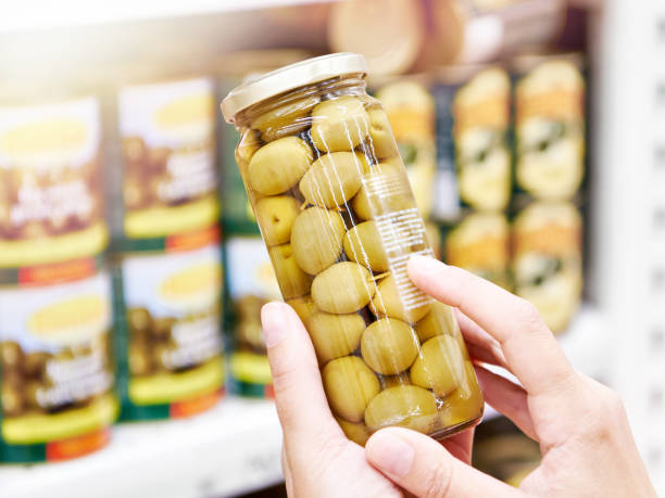 istock Canned olives in hands buyer 1542281053