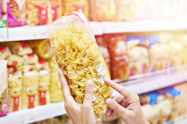 istock Woman with pasta in shop 1542282598