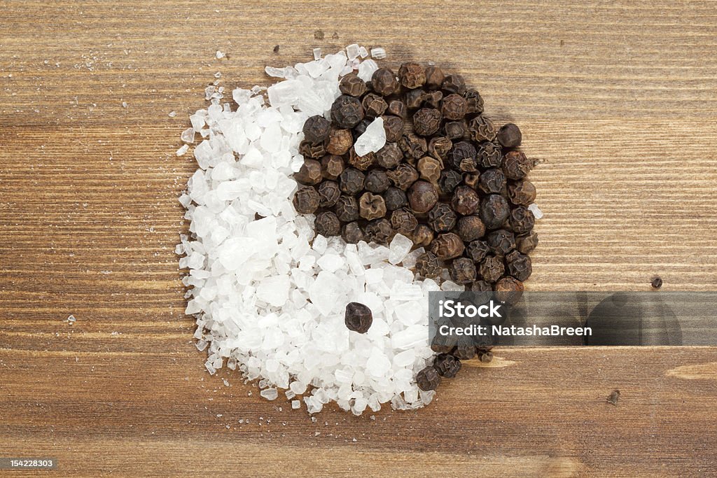 Salt and pepper forming the yin-yang symbol Salt and pepper as yin-jan Asian Culture Stock Photo