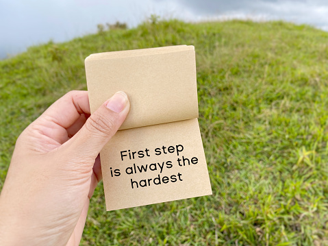 Inspirational motivational quote - first step is always the hardest. Text on paper.