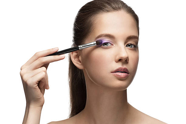 istock Young beautiful woman applying makeup 154229318