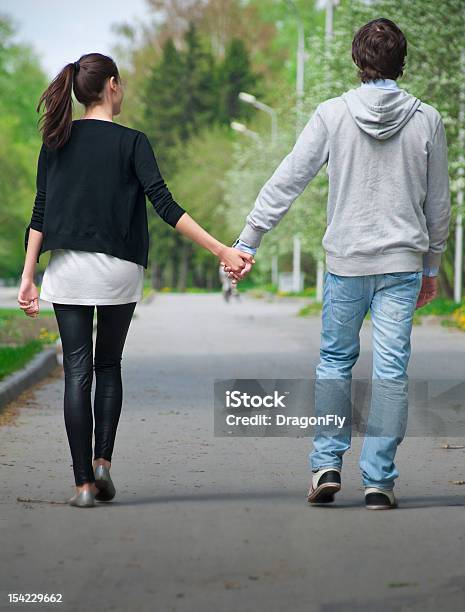 Young Couple Walking Together In Park Stock Photo - Download Image Now - Couple - Relationship, Street, Walking
