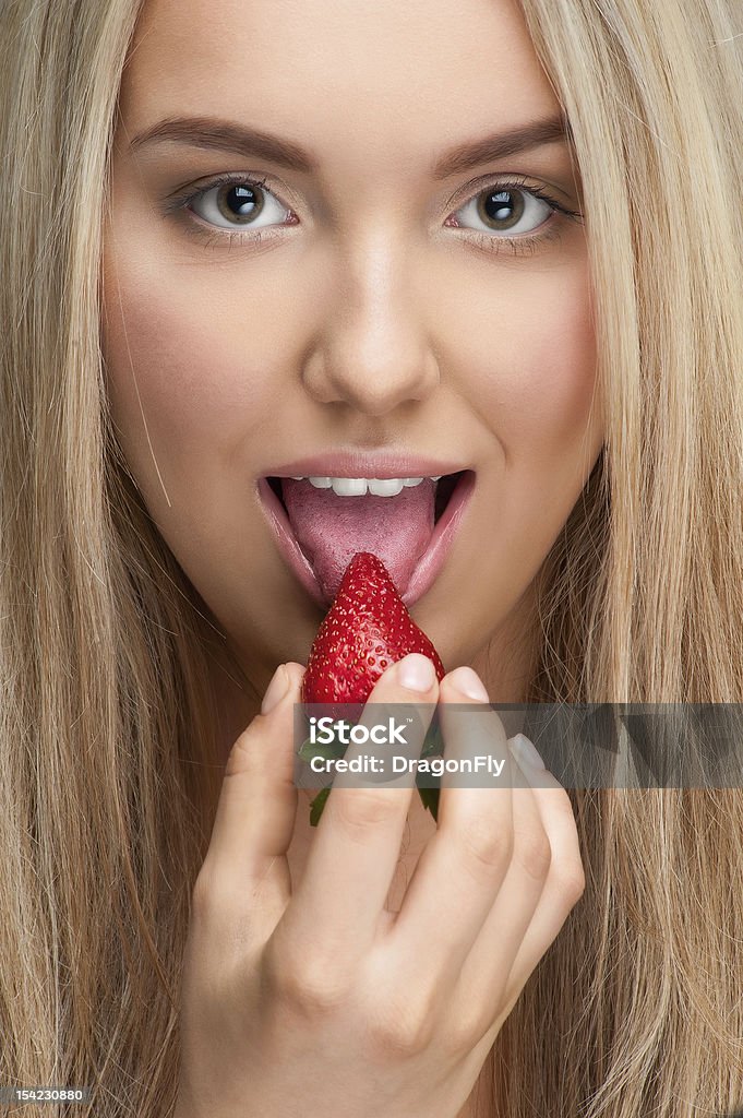 Pretty young woman eating ripe strawberry http://img29.imageshack.us/img29/4803/74495527.jpg Adult Stock Photo